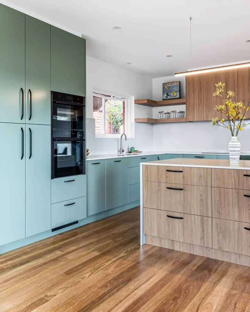 2. Mix Sage Green Flat Front Cabinets With a Wood Grain Island
